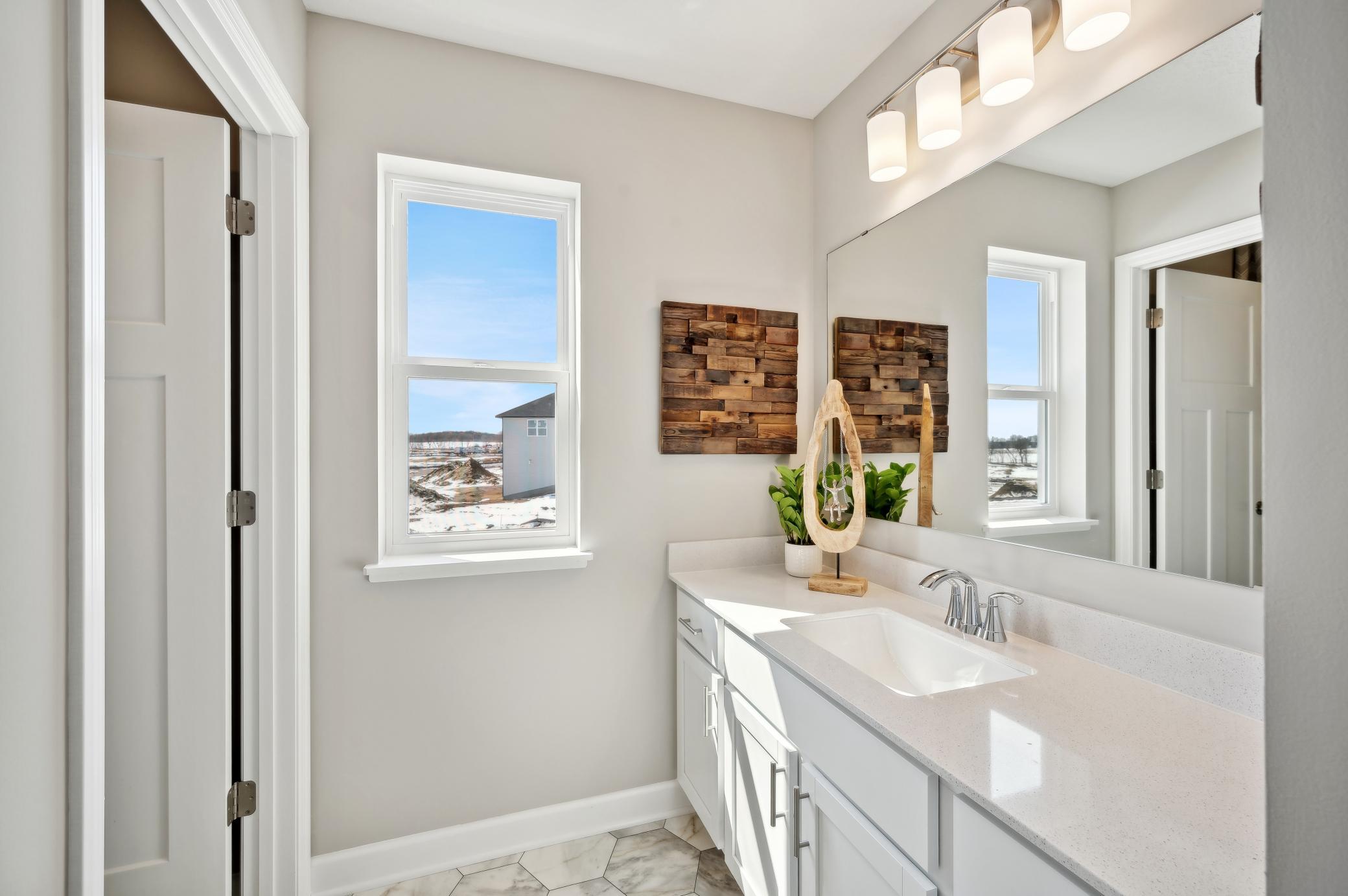 (Photo of model home, finishes will vary) The secondary full bath on the upper level!.jpg