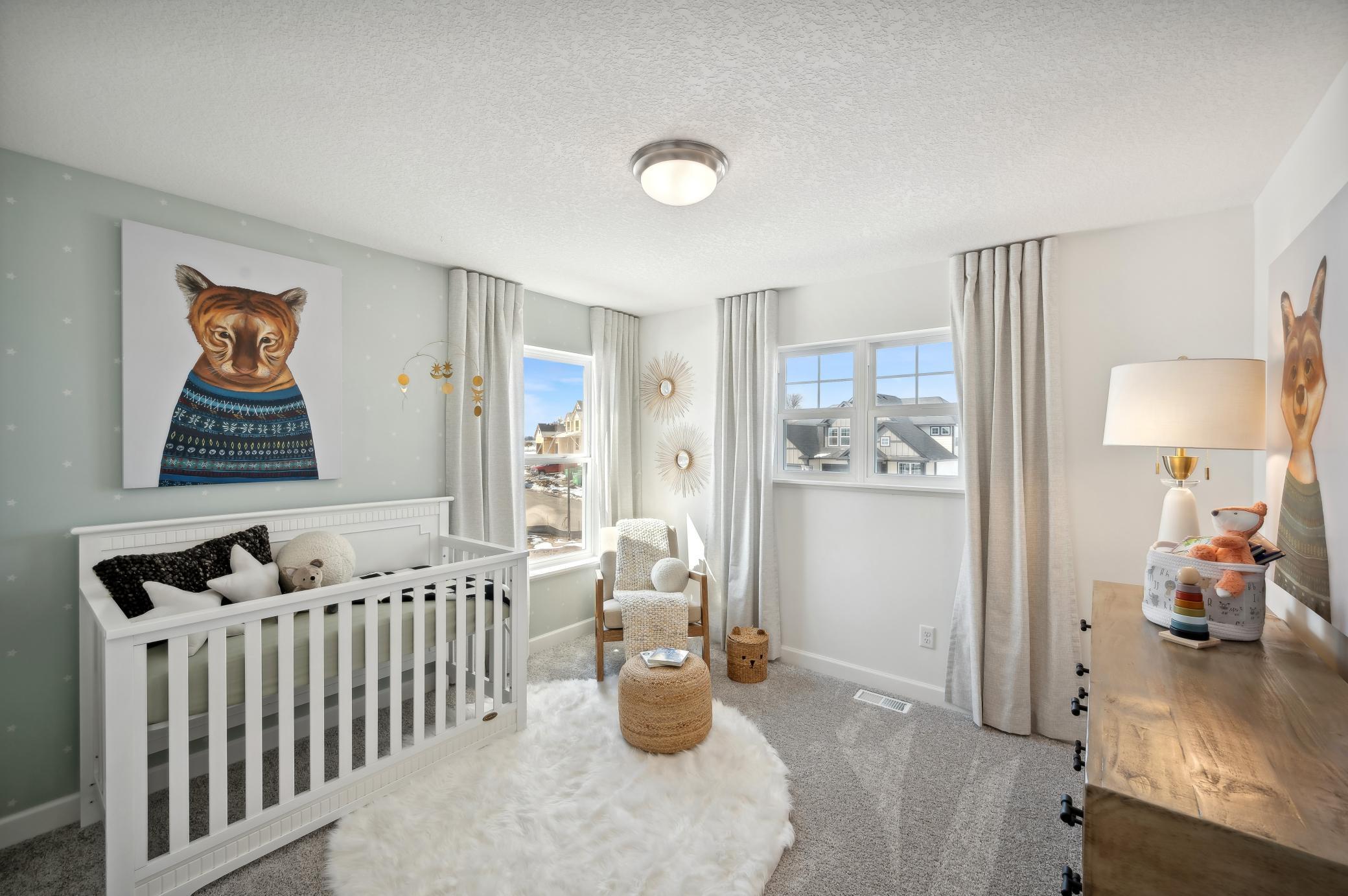 (Photo of model home, finishes will vary) One of the three generously sized upper level secondary bedroom with a spacious closet.