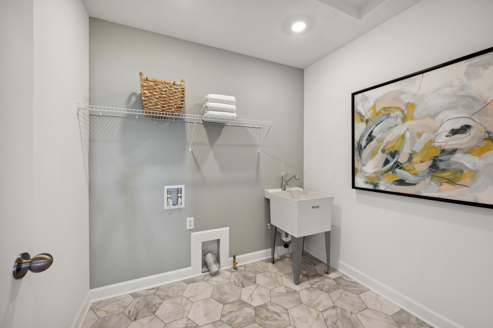 (Photo of model home, finishes will vary) Conveniently located upper level laundry!