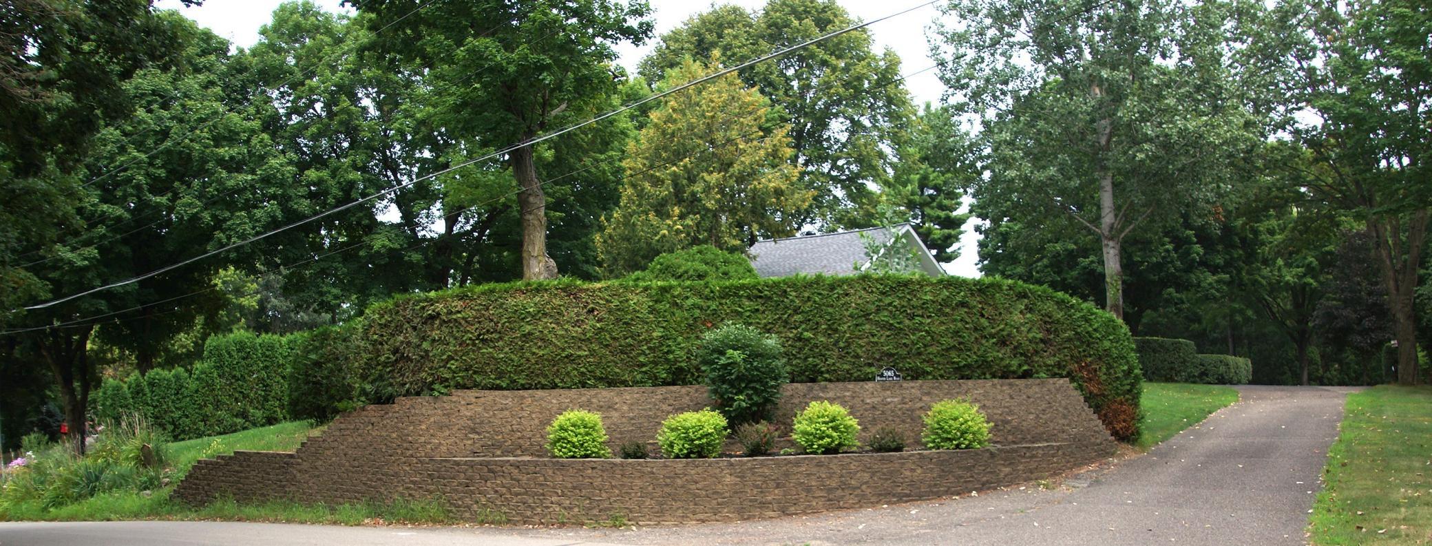 Beautifully landscaped entrance to a .94 acre very private lot in Deephaven. Value is in the land.
