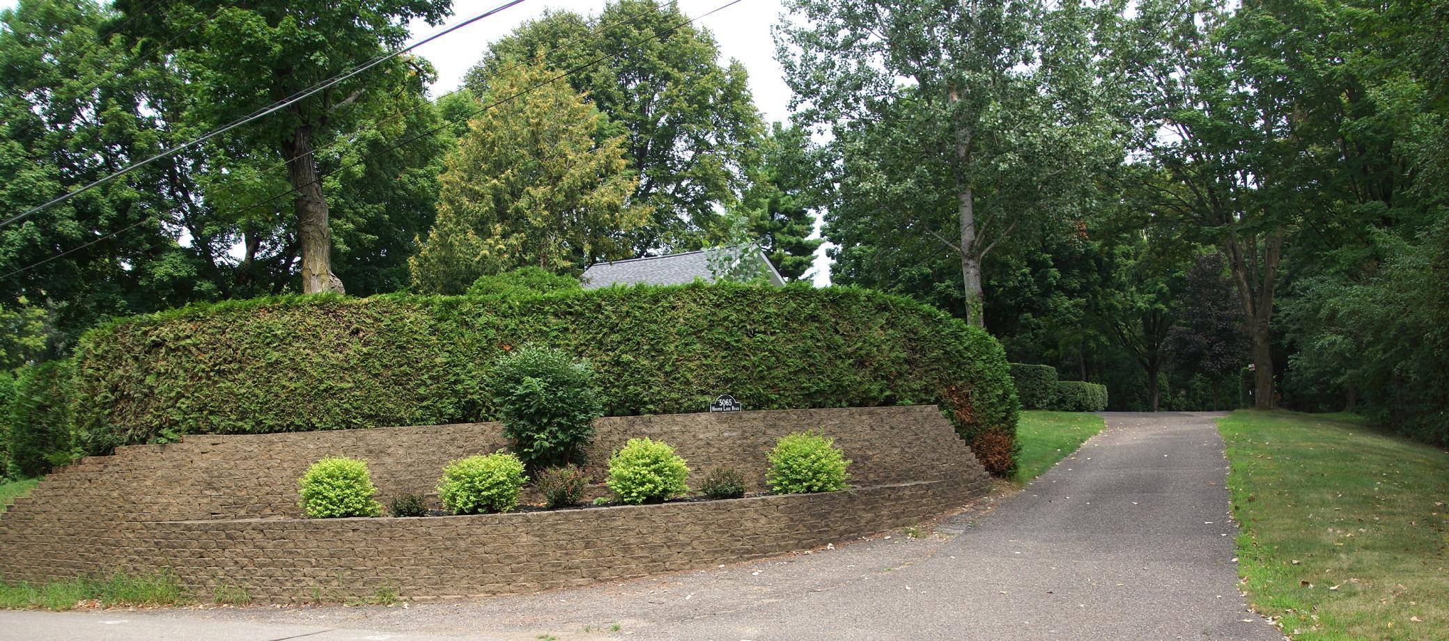 Beautifully landscaped entrance to a .94 acre very private lot in Deephaven. Value is in the land.