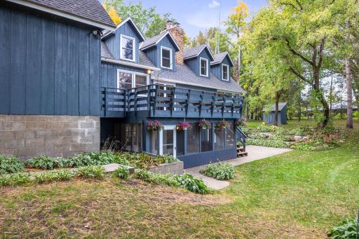 Spacious deck and screened in porch overlooking the beautiful backyard and the amazing views of the Mississippi River.