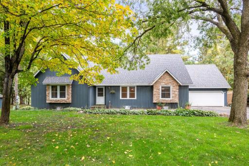 Charming exterior surrounded by mature trees and beautiful landscaping.