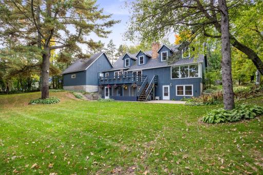 Expansive backyard with mature trees, deck and screened in porch- perfect for enjoying the setting.