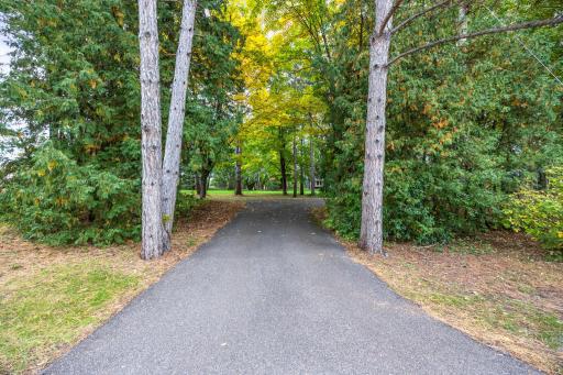 Tree lined paved driveway welcomes you into this private, wooded retreat.