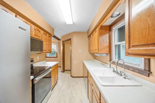 Functional kitchen featuring ample cabinetry, generous counter space and stainless steel appliances.