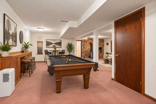 Generous lower level recreation area with plenty of room for a pool table and additional seating. Virtually Staged