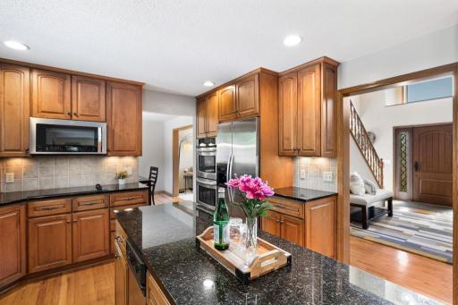 Kitchen sink with granite counters and backyard views