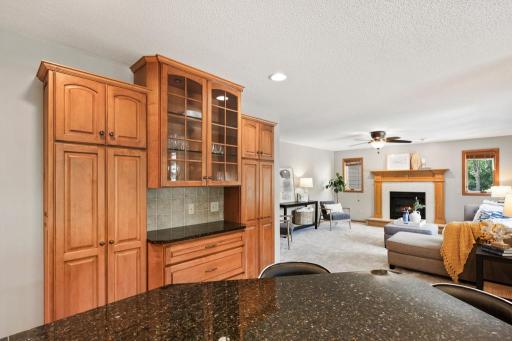 Dining nook with ceiling fan and expansive windows