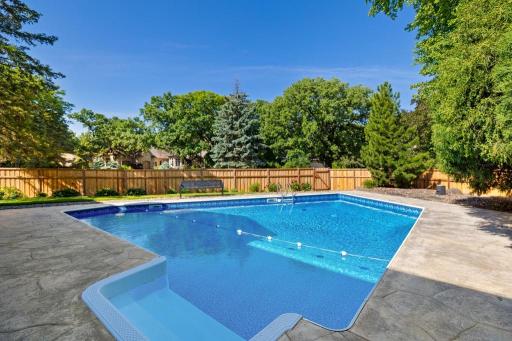 Aerial view of landscaped property, pool and surrounding area