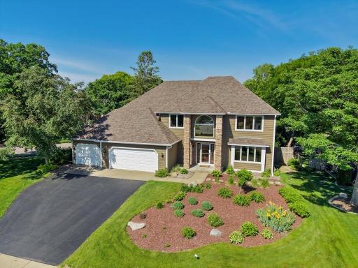 Aerial view of home, landscaped yard and driveway