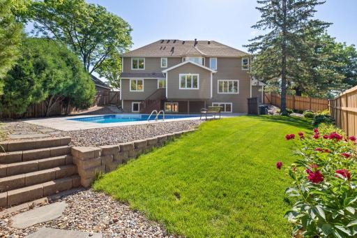 In-ground pool with patio and landscaped yard