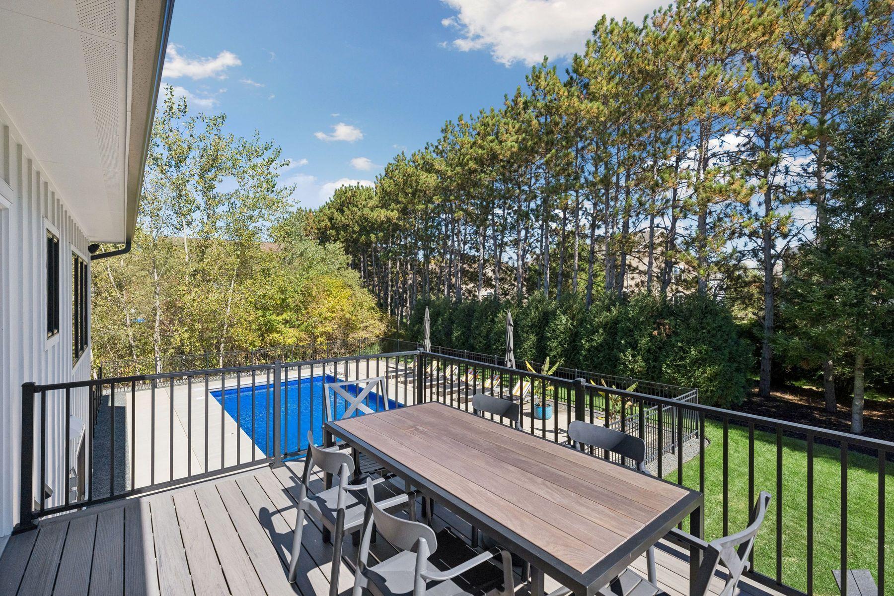Deck overlooks the stunning pool and backyard