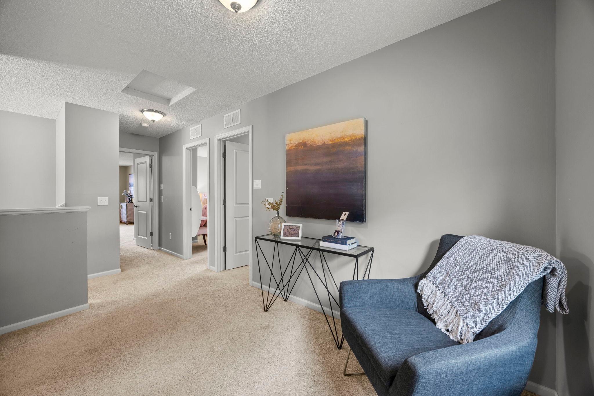 Versatile landing space that works well as a reading nook, office, or lounge.