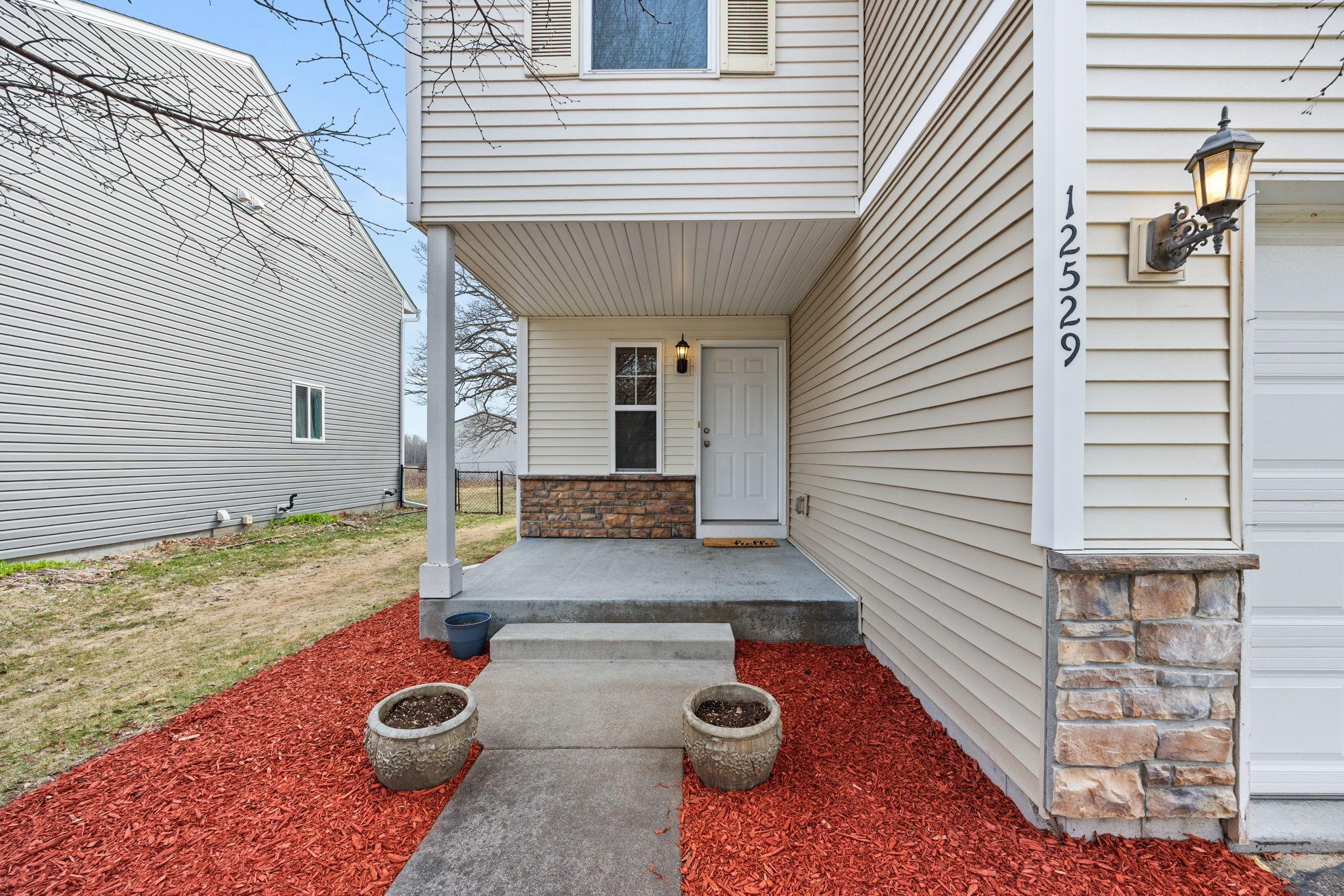 Outdoors, the home continues to impress with a welcoming covered front porch.