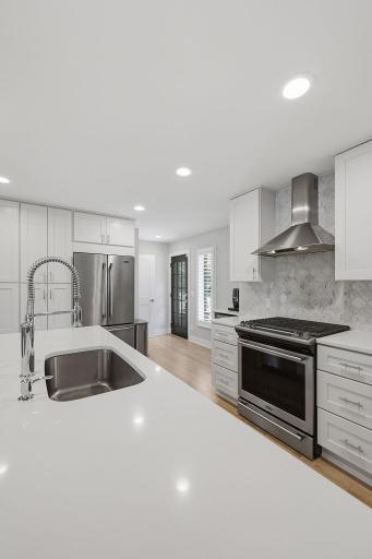Sleek and bright with a counter-to-ceiling tiled backsplash, this is a chef's dream.