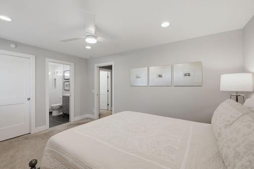 Your main level primary suite offers a walk-in closet featuring custom closets along with your own private bathroom.
