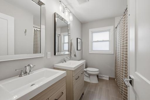 Perfect for you or your guests, double vanities and and stylish tilework complete the main level full bathroom.
