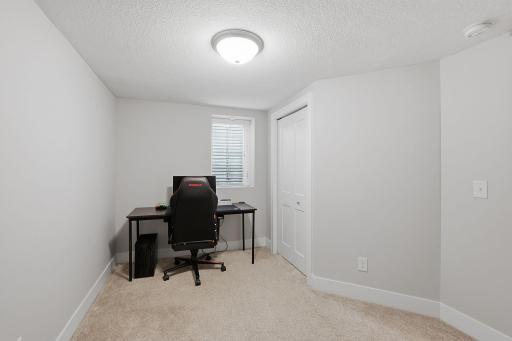 A comfy office area and custom closet fill out the third bedroom.