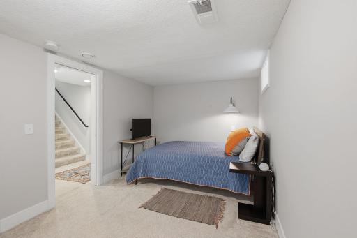 A third bedroom is positioned perfectly at the end of the lower level.