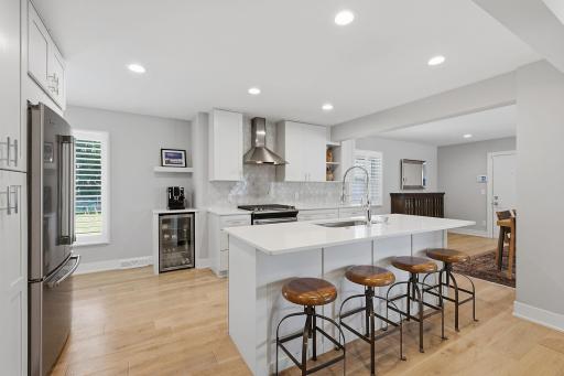 A central quartz island is expertly positioned for prep and gathering with friends.