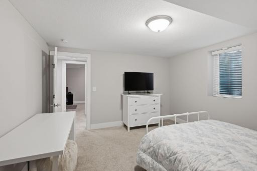 The fourth and final bedroom is spacious and features more custom closet work.