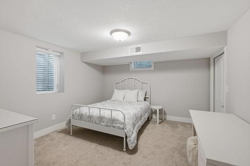 The fourth and final bedroom is spacious and features more custom closet work.