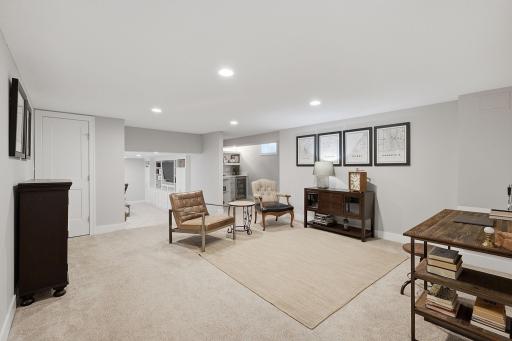 Step down to the lower level where this flexible lounge area invites you to relax.