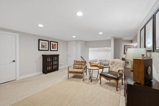 Step down to the lower level where this flexible lounge area invites you to relax.