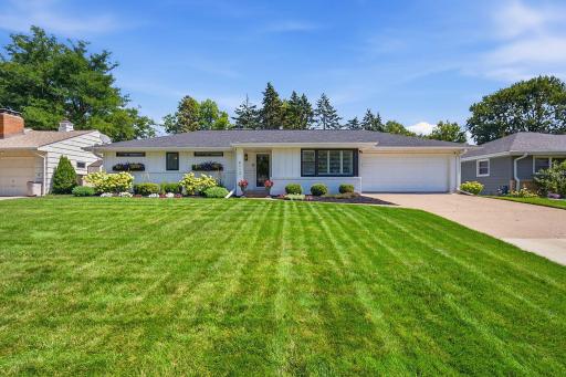 Lush landscaping with in-ground irrigation and an expansive front yard greet you here.
