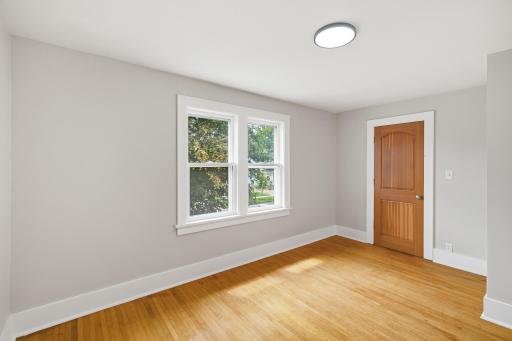 Bedroom one with hardwood floors