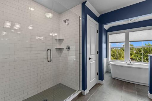 Primary bathroom with walk in shower and freestanding soaker tub