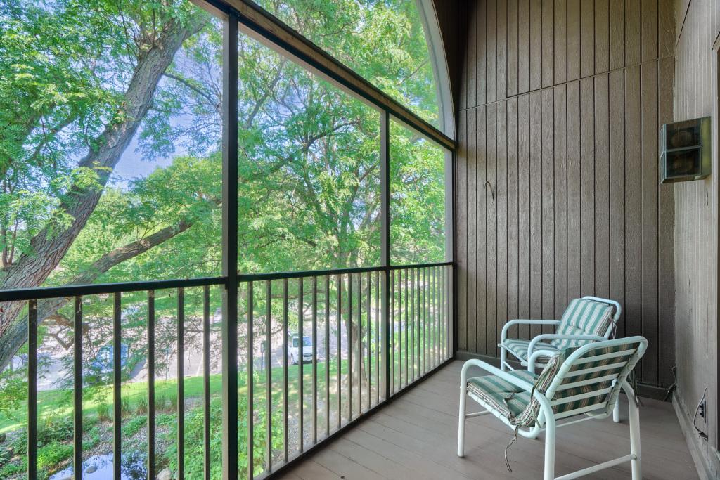 An amazing feature to this condo - screened porch and generous seating area. Overlooks fountain and trees for a peaceful feeling.