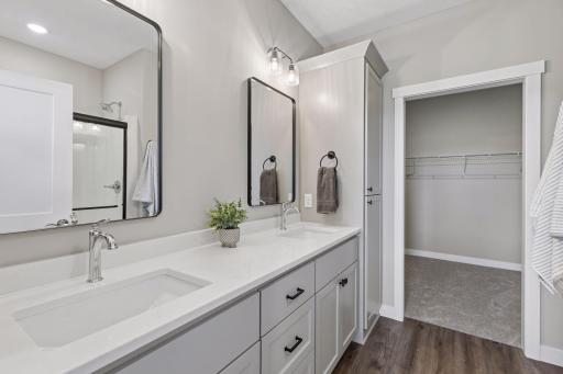 Private primary bathroom features dual sink vanity