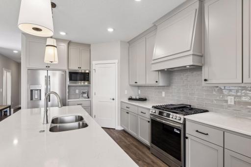 Stainless steel appliances and decorative tile backsplash
