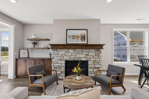 Living room showcases a gorgeous stone gas fireplace with built-in cabinetry
