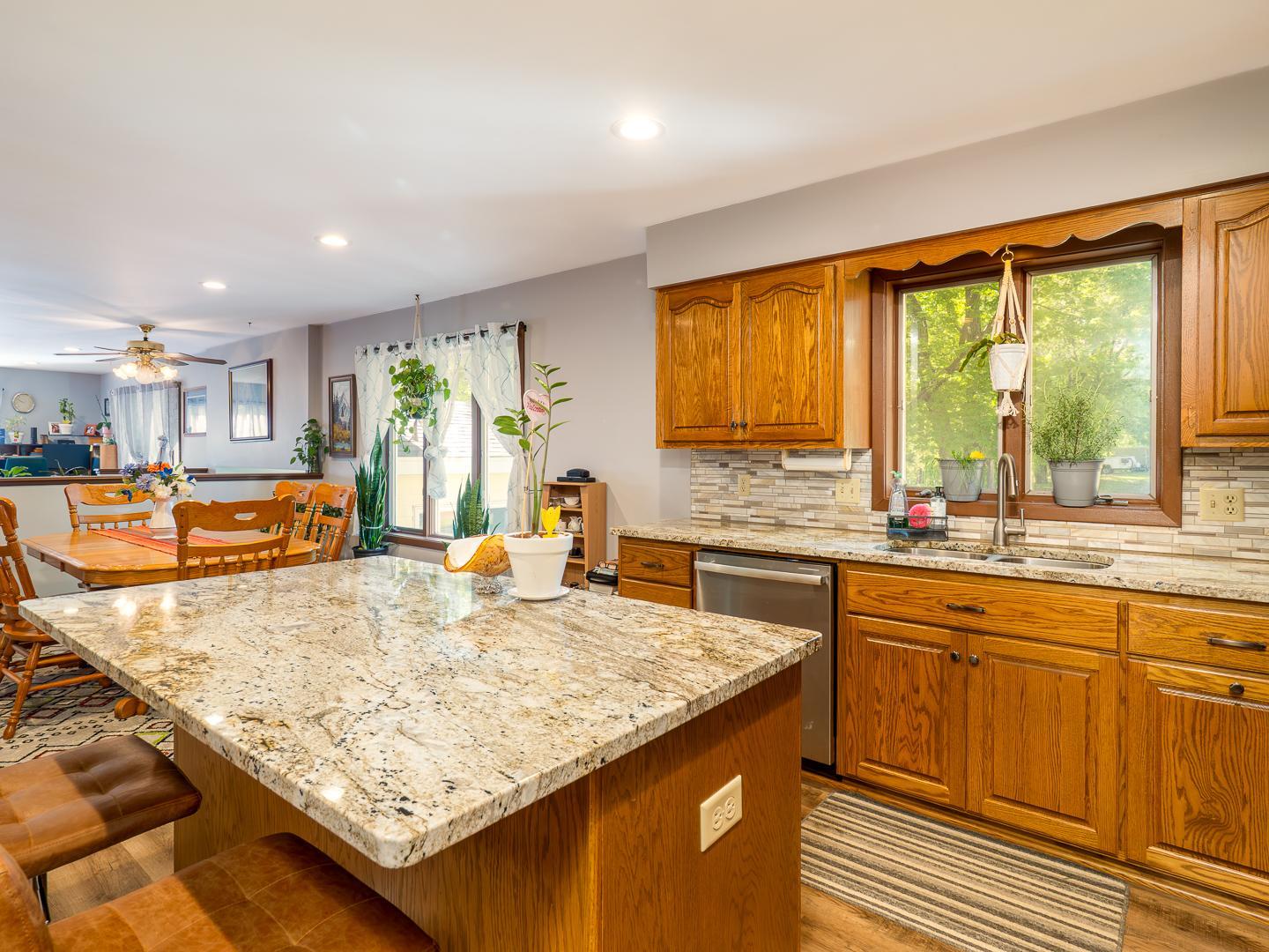 Large center island with hard surface countertop.