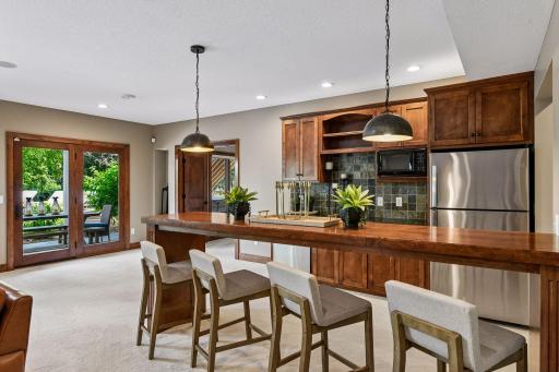 Luxury meets livability in this inviting entertainment space, highlighted by custom millwork, a designer wet bar, and effortless indoor-outdoor flow. Ideal for memorable gatherings and refined everyday living.