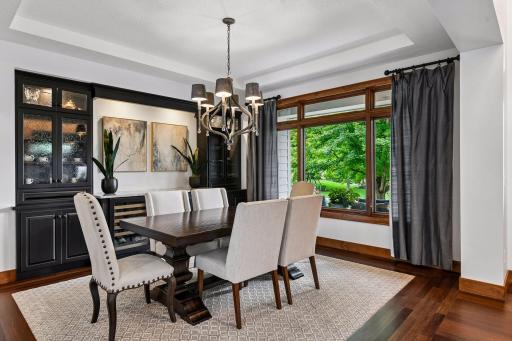 Host unforgettable gatherings in this elegant dining room, where custom built-ins, and expansive windows create a sophisticated backdrop. Designed for refined entertaining, this space blends timeless style with everyday luxury.