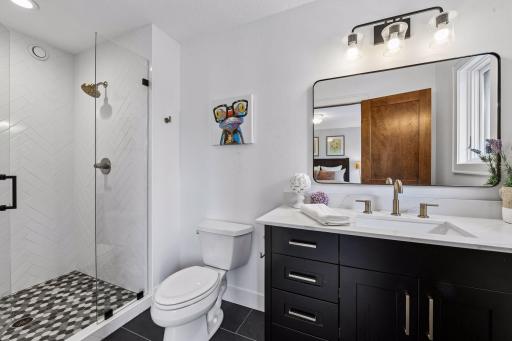 Beautifully renovated ensuite bath offering spa-inspired luxury with heated tile floors, a designer vanity, and an elegant tile-surround walk-in shower. Premium finishes and thoughtful craftsmanship create a sophisticated private retreat for everyday