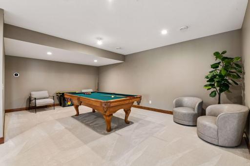Elevate game night in this expansive lower-level recreation room, offering endless possibilities for billiards, gaming, fitness, or entertaining. Thoughtfully designed with generous space and seamless flow to adjoining gathering areas.