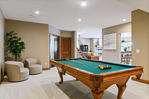 The ultimate entertainment destination for the lower level which seamlessly connects to adjacent family room, workout room and bar areas. Everyone can be part of the fun to not miss out on the action.