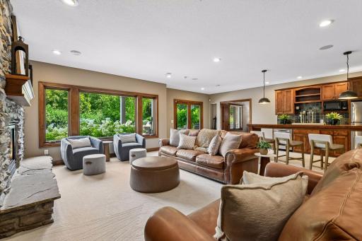 Be the destination for every celebration in this exceptional walkout lower level, offering seamless sightlines to a private backyard oasis with a pool and elevated lounging decks. A perfect blend of luxury, comfort, and year-round entertaining.