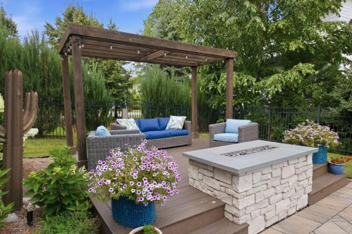Escape to your private outdoor retreat, where a custom pergola, elegant fire feature, and lush landscaping create the perfect setting for relaxation and entertaining. Thoughtfully designed for intimate evenings or lively gatherings. Oasis to enjoy!