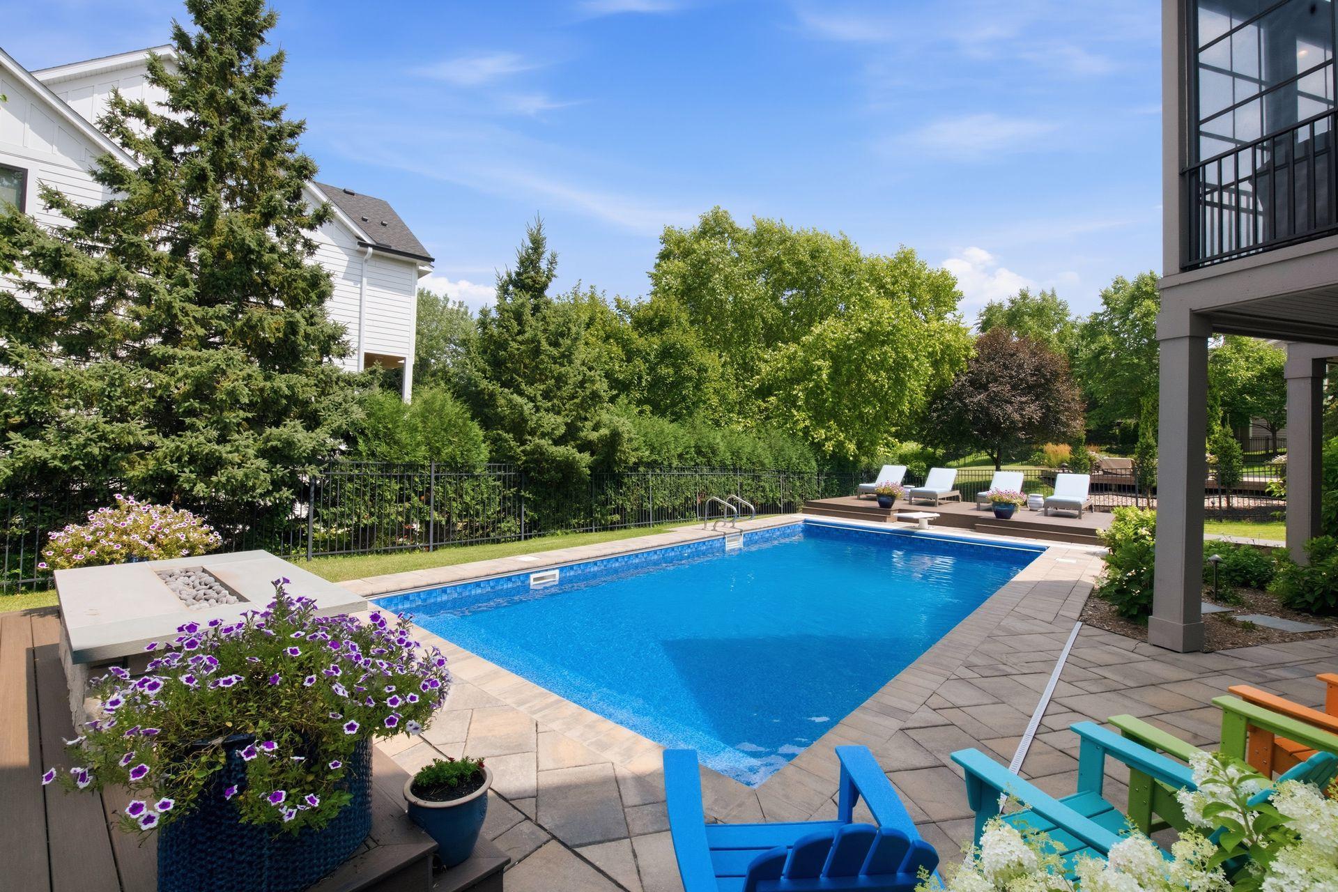 Exceptional setting for outdoor entertaining, relaxation and ambiance with a gas stone fireplace, 30x13 patio, 32x16 heated pool and two raised maintenance-free decks (20x14 & 14x14)