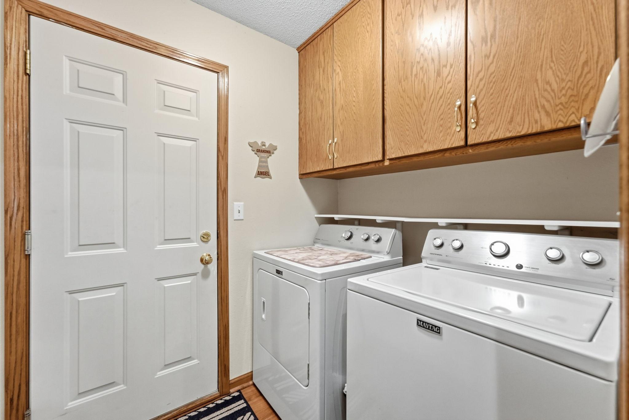 Convenient main floor laundry with storage for organization.