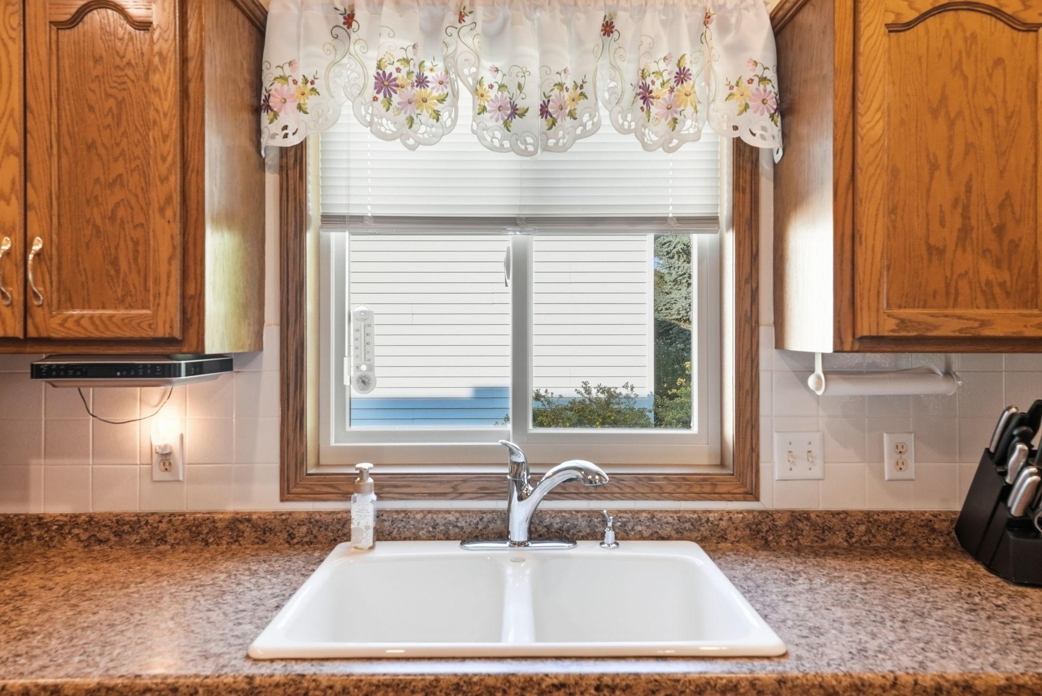 Kitchen window lookout allows natural light to flood into this space.