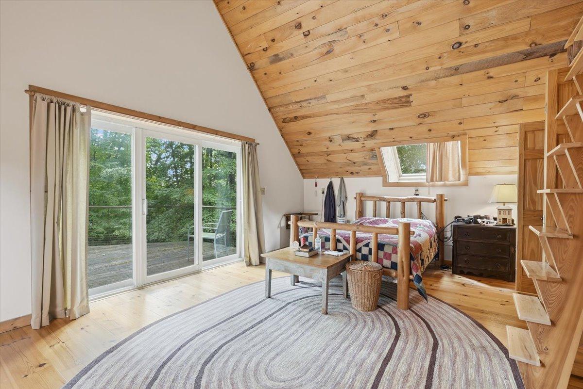 Third level bedroom with access to the attic and deck outdoors