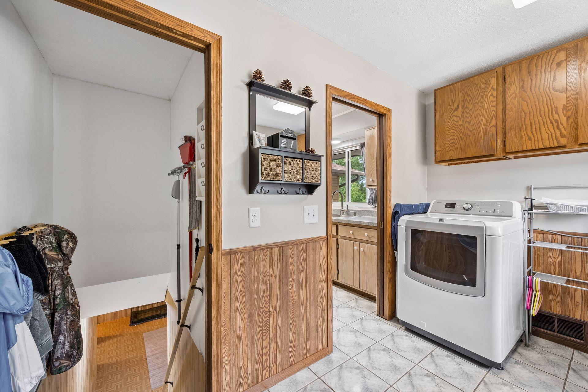 The main floor laundry has the main stairway to the lower level.