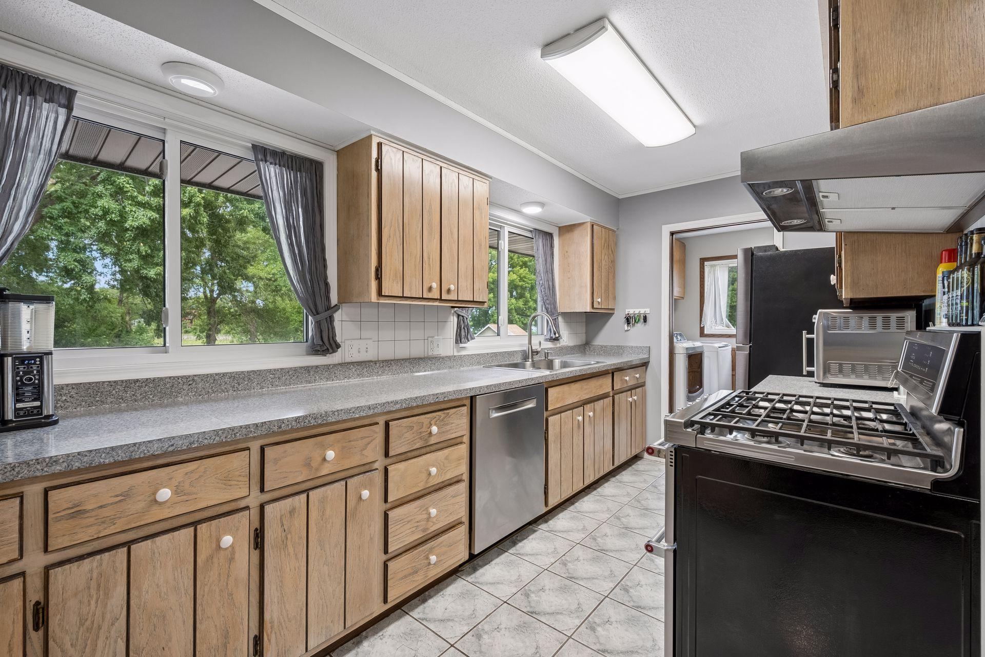 The kitchen has stainless appliances along with plenty of counter and cupnboard space
